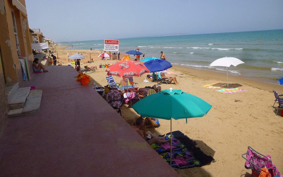 Familier og parasoller på Playa Babilonia ved Guardamar del Segura
